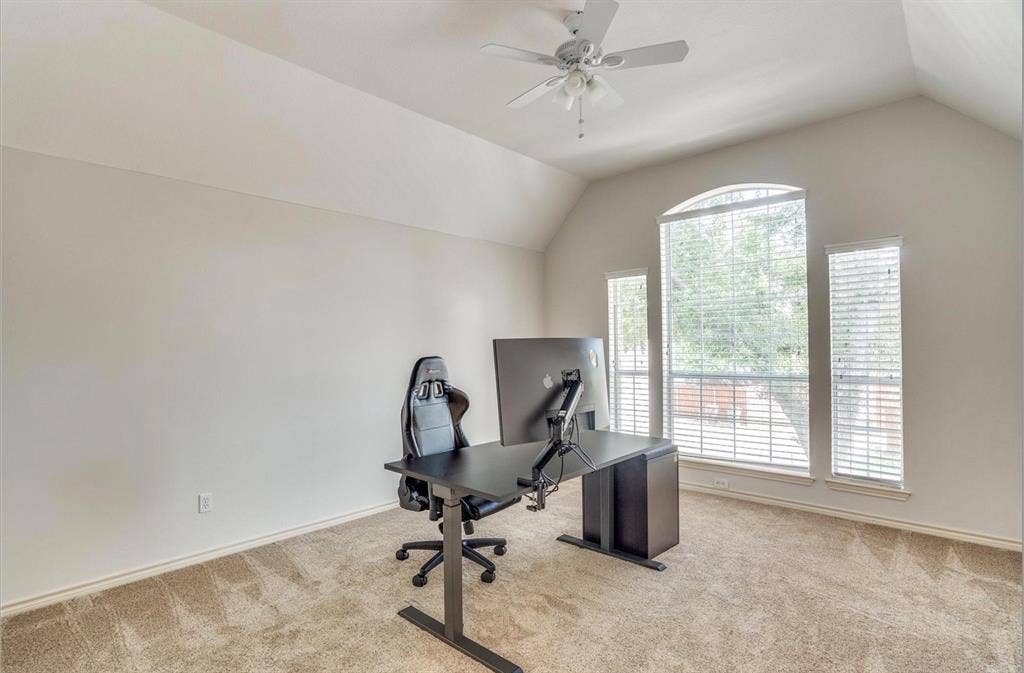 1944 Vantage Drive, Plano, TX 75075 Vaulted ceiling with a ceiling fan, arched window, two rectangular windows, and carpet flooring