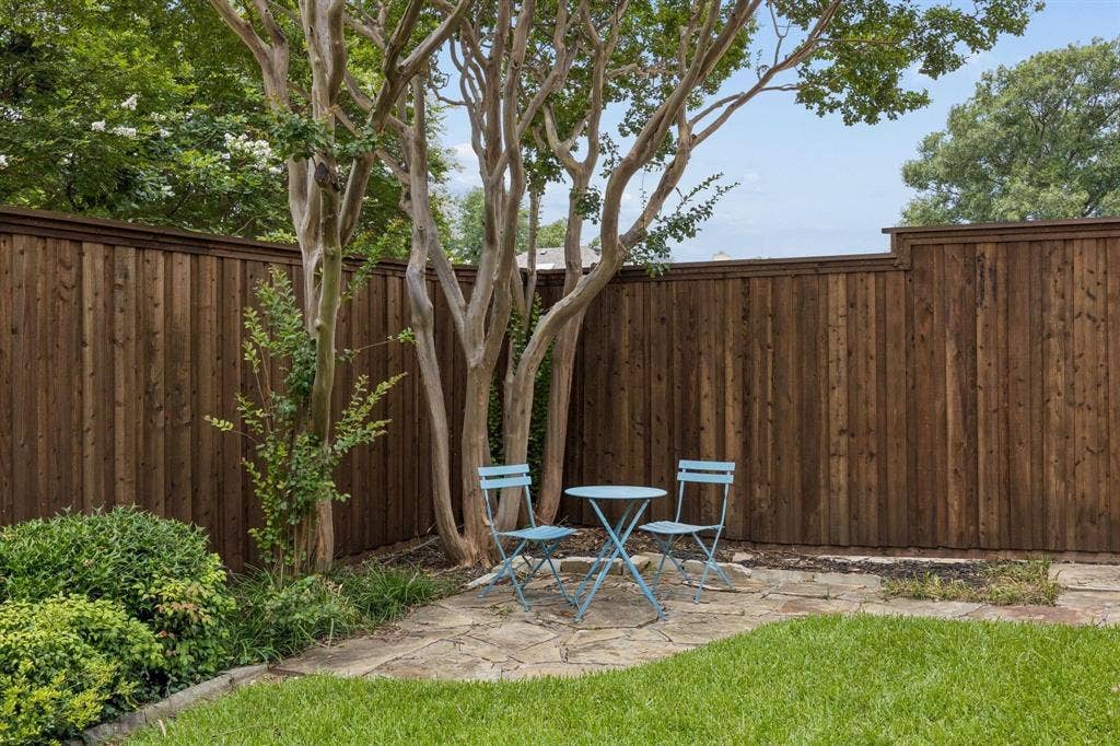 3104 Congress Avenue, Plano, TX 75025 Manicured lawn with a stone patio, mature trees, and a privacy fence