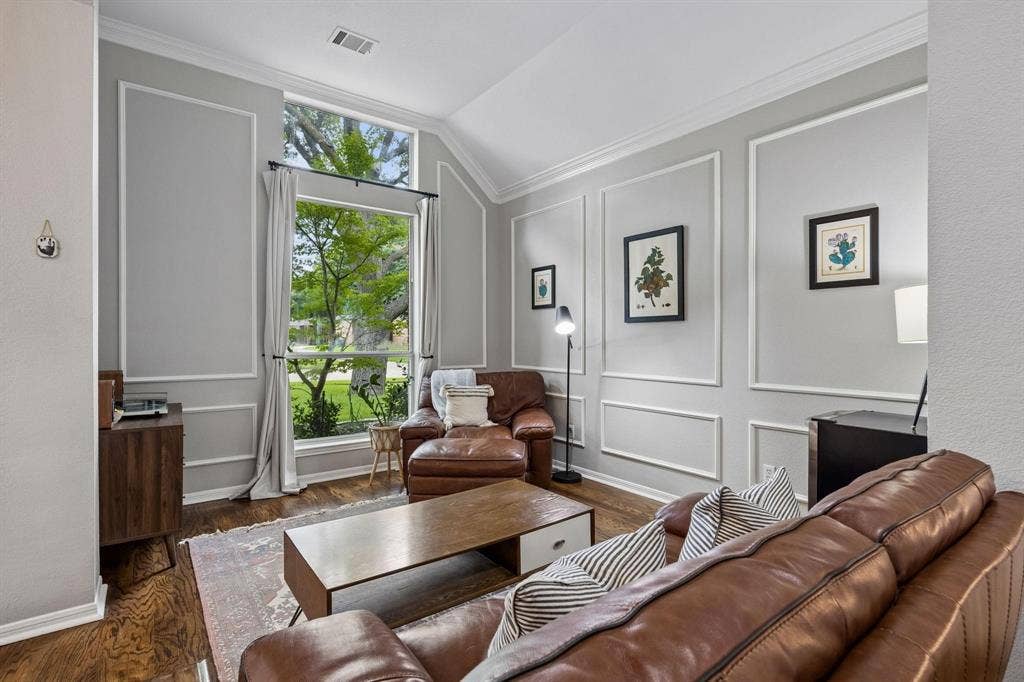 3104 Congress Avenue, Plano, TX 75025 Accent wall with decorative molding, wood-finish flooring, and a large picture window