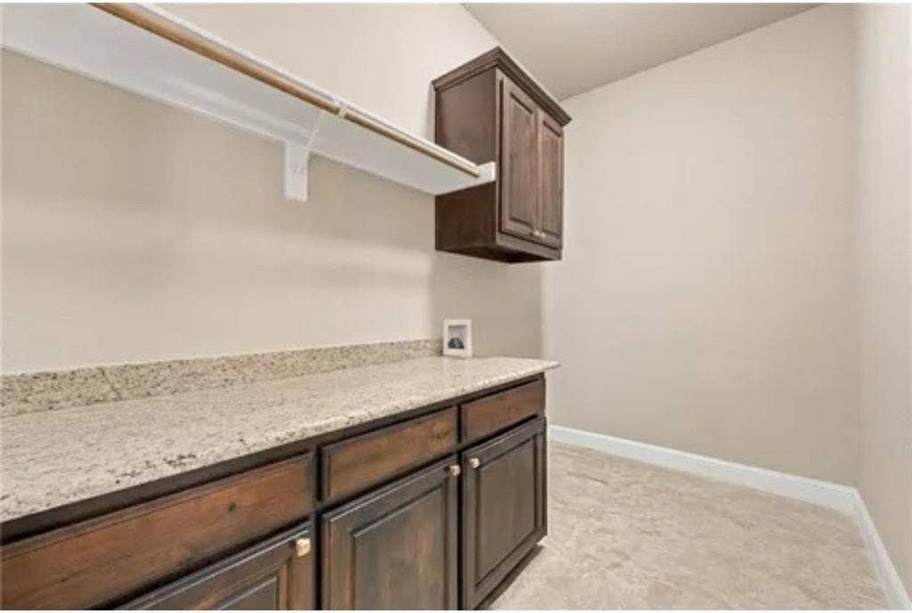 2313 Therese, Waco, TX 76712 Built-in cabinetry with bronze hardware, a light-toned countertop, and tile flooring
