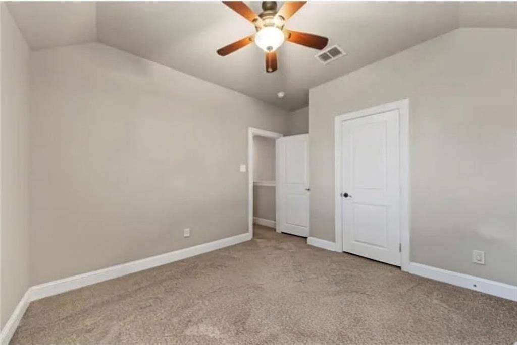 2313 Therese, Waco, TX 76712 Vaulted ceiling with a ceiling fan light fixture, neutral-toned carpet, and white trim