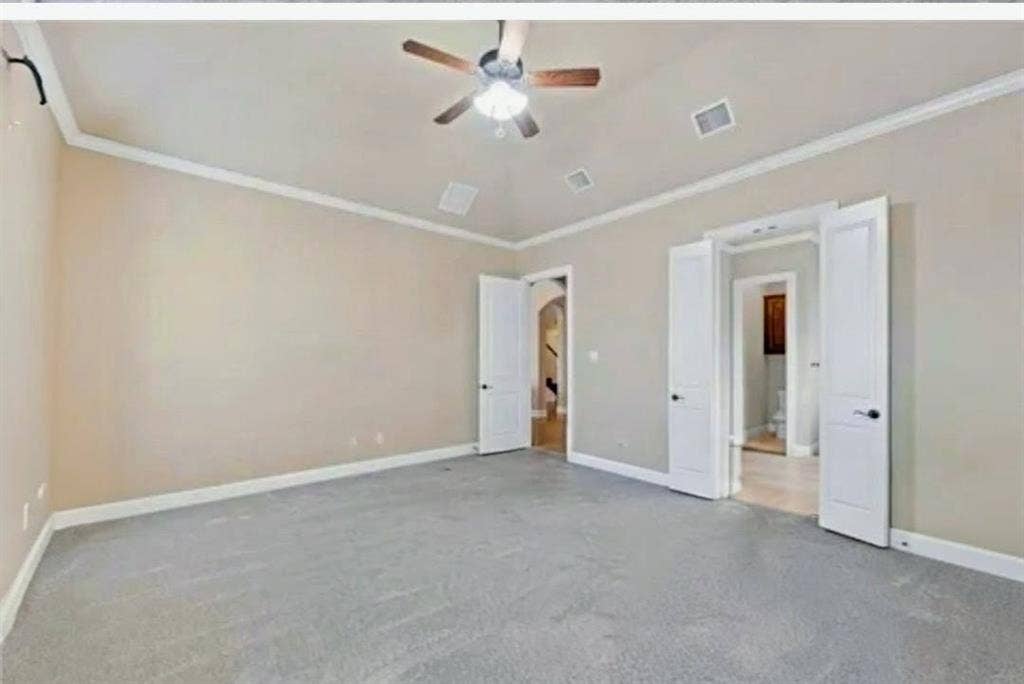 2313 Therese, Waco, TX 76712 Carpeted room featuring a ceiling fan, crown molding, and two sets of double doors