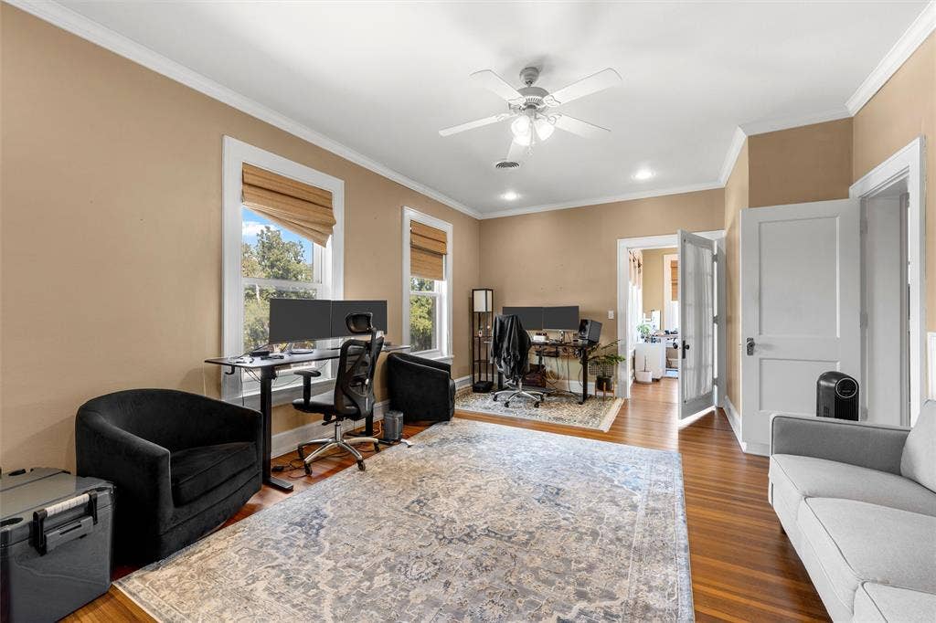2424 Austin Avenue, Waco, TX 76701 Hardwood flooring, crown molding, ceiling fan, recessed lighting, and multiple windows with blinds
