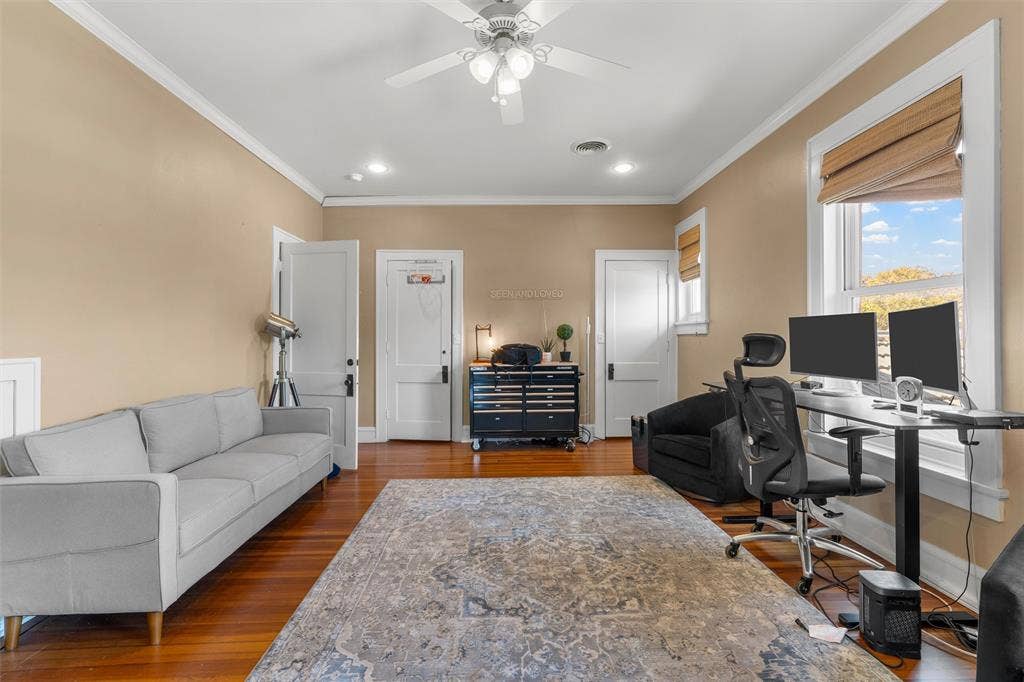 2424 Austin Avenue, Waco, TX 76701 Hardwood flooring, painted walls, ceiling fan with integrated lighting, and two windows providing natural light