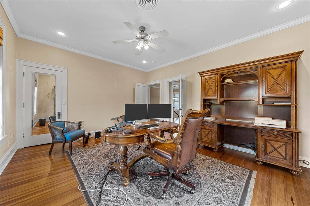 2424 Austin Avenue, Waco, TX 76701 Wood-finish flooring, recessed lighting, crown molding, ceiling fan, and built-in desk cabinetry