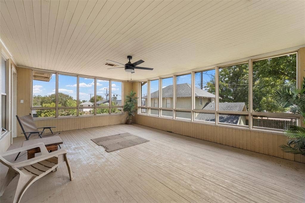 2424 Austin Avenue, Waco, TX 76701 Enclosed porch with extensive window panels, wood-finish flooring, beadboard ceiling, and a ceiling fan
