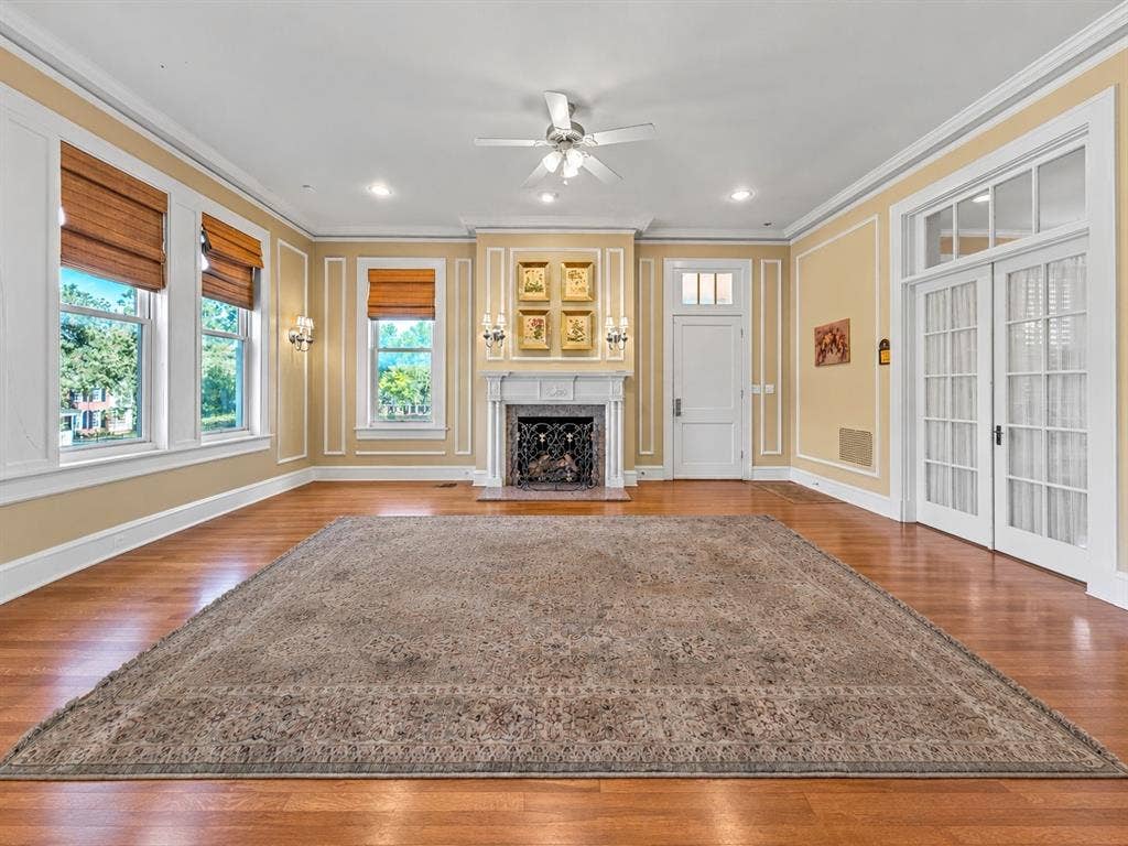2424 Austin Avenue, Waco, TX 76701 Hardwood flooring, decorative wall molding, fireplace with mantel, ceiling fan, and French doors