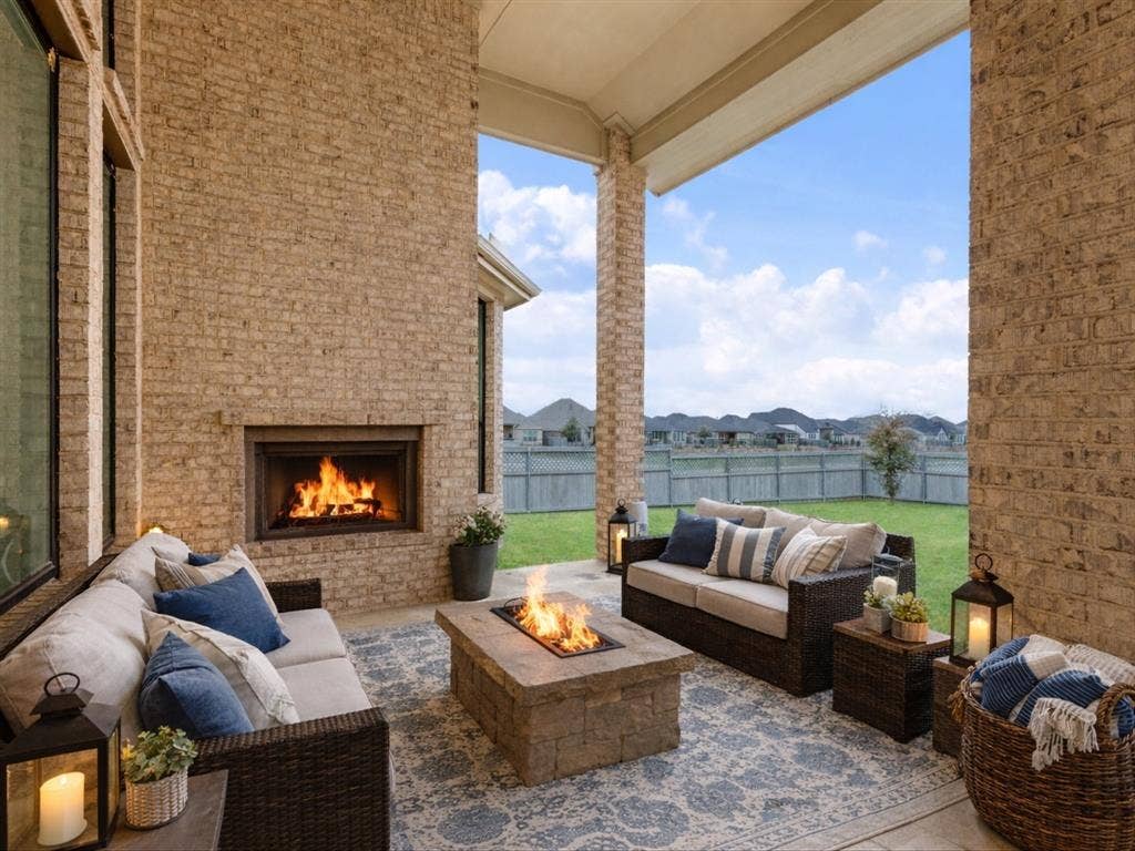 508 N Pecan Parkway, Northlake, TX 76247 Covered patio with brick walls, a built-in outdoor fireplace, and a stone fire pit