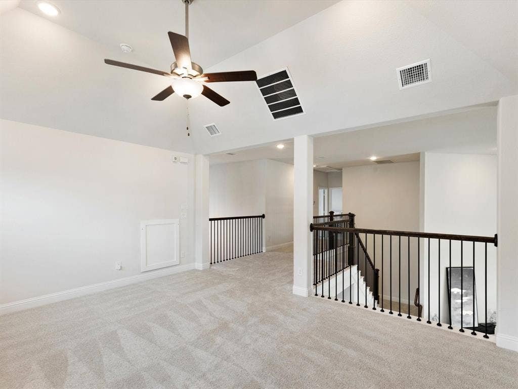 508 N Pecan Parkway, Northlake, TX 76247 Carpeted loft area featuring a ceiling fan with integrated lighting, recessed lighting, and dark metal balusters