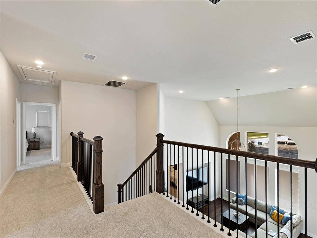 508 N Pecan Parkway, Northlake, TX 76247 Carpeted hallway with wood and metal baluster staircase