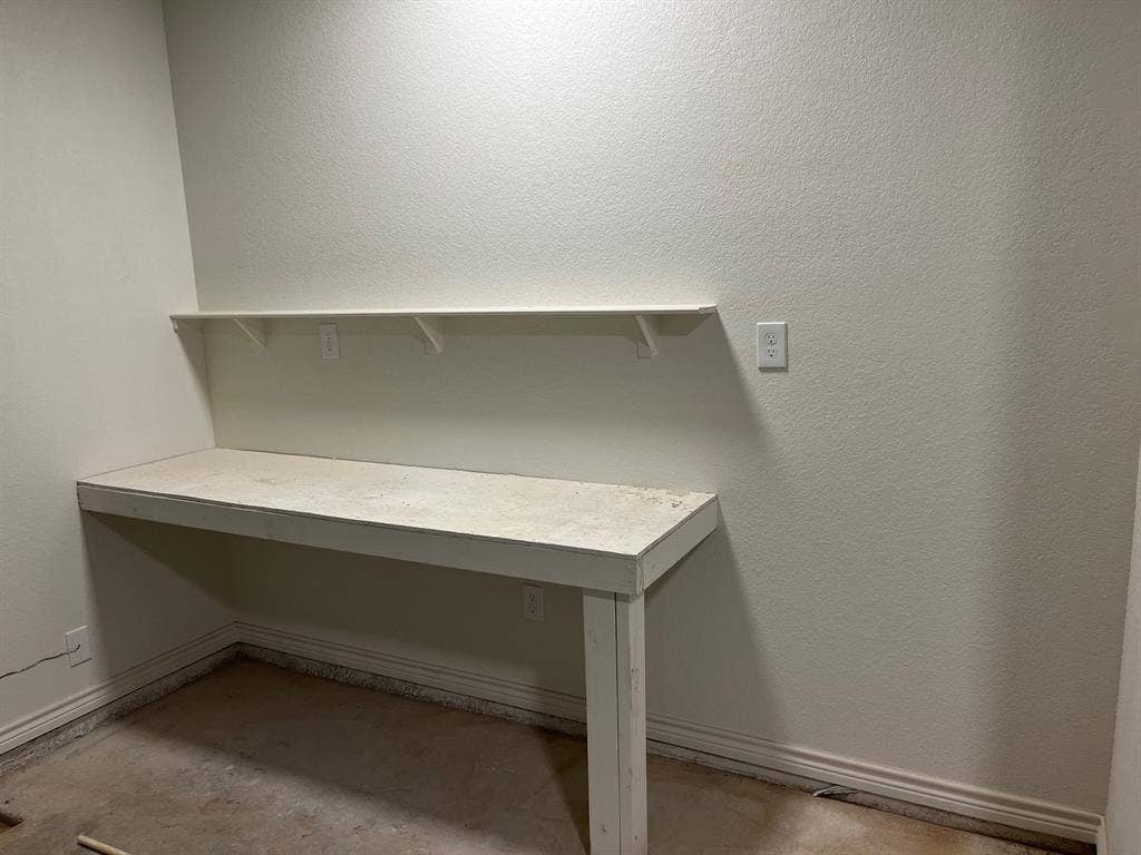 5718 Barkridge Drive, Granbury, TX 76048 Work Bench in the garage with outlets, Lights and space for tool chest or extra fridge.