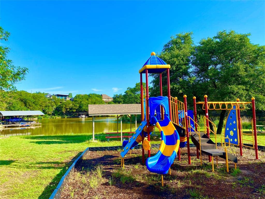 5718 Barkridge Drive, Granbury, TX 76048 Playground near the lake with park benches and tables