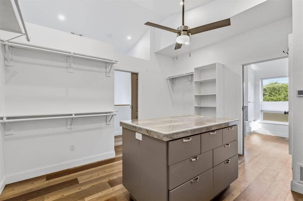 Wood-finish flooring, vaulted ceiling, and recessed lighting