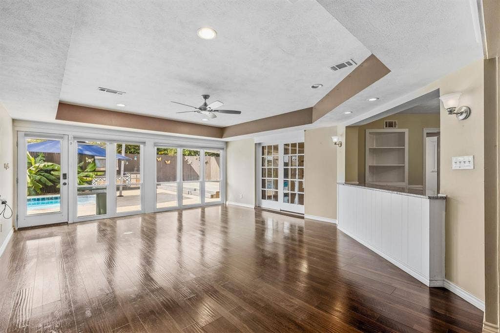 Wood-finish flooring throughout, recessed lighting, and a ceiling fan