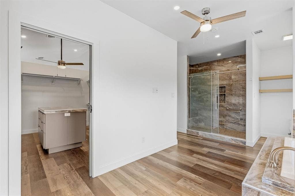 Wood-finish flooring throughout, with a built-in walk-in closet island and shelving