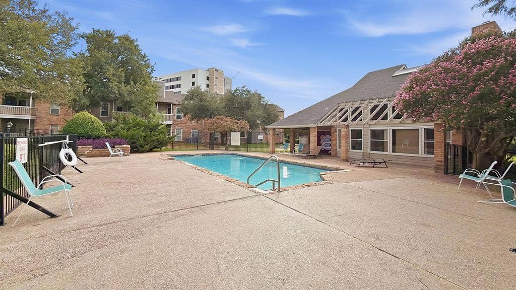 1700 Amelia Court, #126, Plano, TX 75075 Outdoor swimming pool with integrated steps, surrounding concrete decking, and black metal fencing