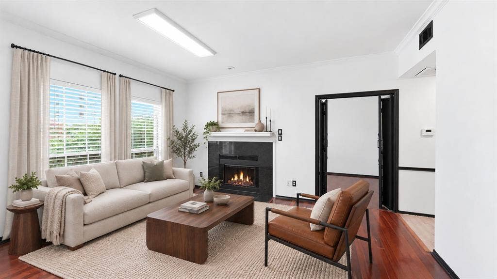 1700 Amelia Court, #126, Plano, TX 75075 Fireplace with a black stone surround and white mantel Virtually staged
