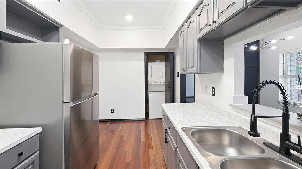 1700 Amelia Court, #126, Plano, TX 75075 Stainless steel refrigerator, wood-finish flooring, gray cabinetry, dual basin stainless steel sink, and a black gooseneck faucet