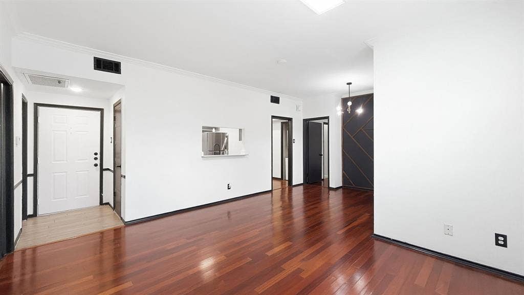 1700 Amelia Court, #126, Plano, TX 75075 Hardwood flooring, crisp white walls, contemporary chandelier, recessed lighting, and a pass-through window