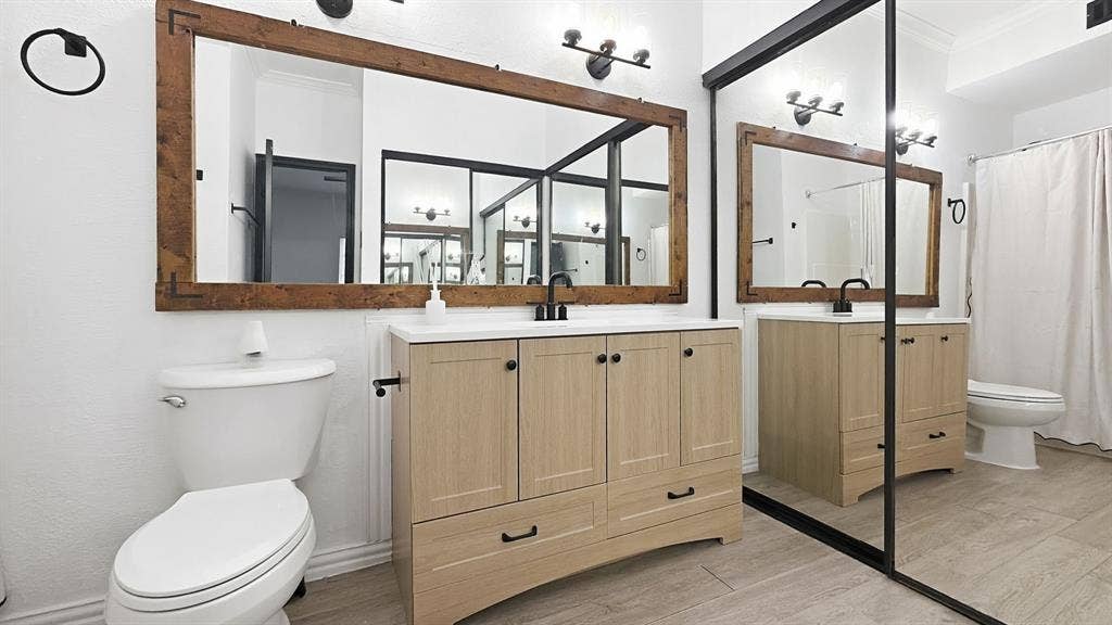 1700 Amelia Court, #126, Plano, TX 75075 Light wood-finish vanity with a white countertop and black hardware