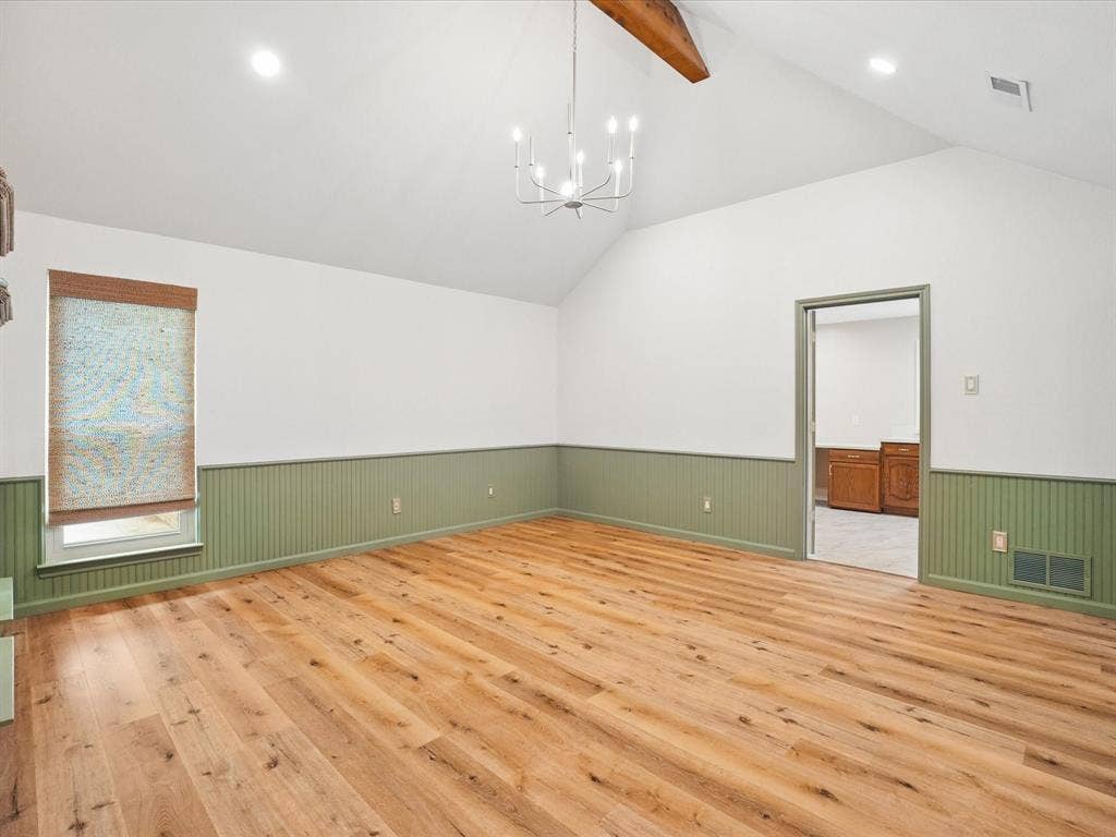 1304 Carriage Creek Drive, DeSoto, TX 75115 Vaulted ceiling with exposed wood beam, wood-finish flooring, recessed lighting, and chandelier