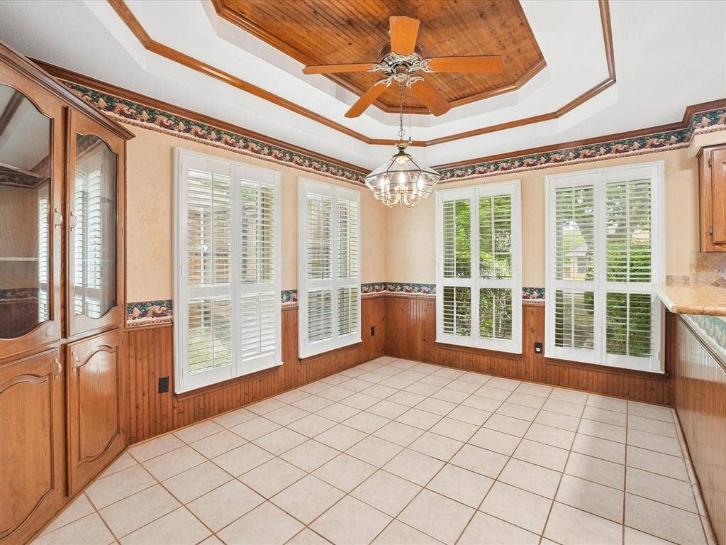1304 Carriage Creek Drive, DeSoto, TX 75115 Recessed ceiling with wood-paneled inlay, ceiling fan, and chandelier