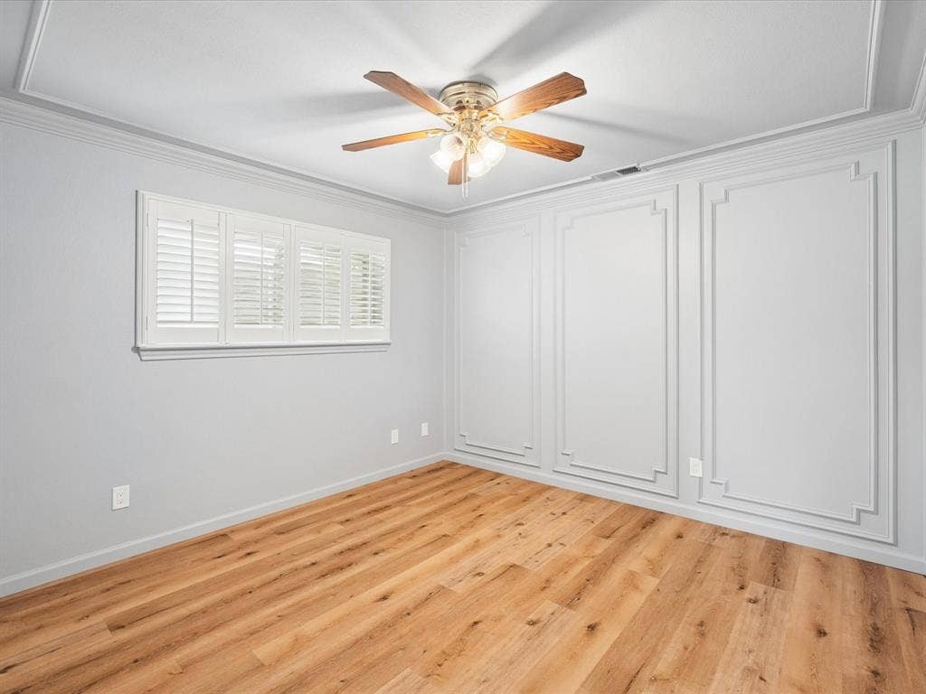 1304 Carriage Creek Drive, DeSoto, TX 75115 Wood-finish flooring throughout, crown molding, and decorative wall paneling