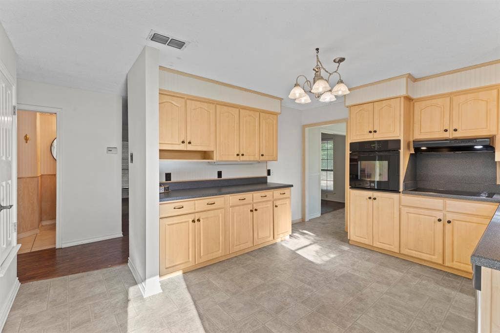 1656 Pineview Lane, Hideaway, TX 75771 Kitchen featuring wood-finish cabinetry, dark countertops, built-in wall oven, and tile flooring