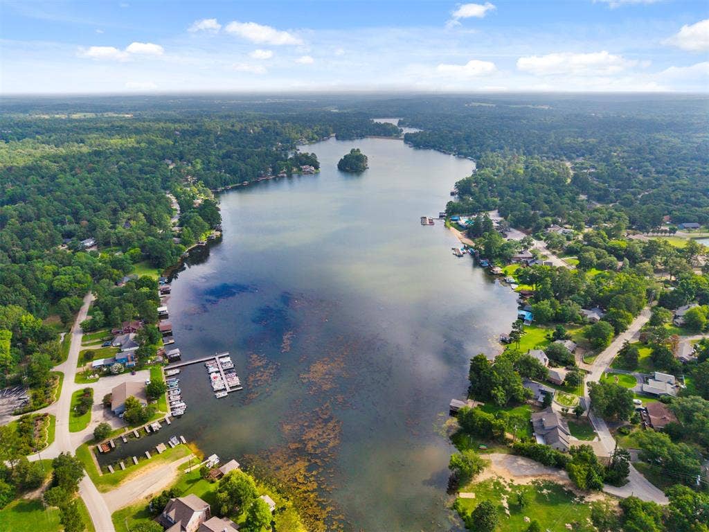 1656 Pineview Lane, Hideaway, TX 75771 Expansive lakefront setting featuring a central island, multiple docks, and surrounding wooded shoreline
