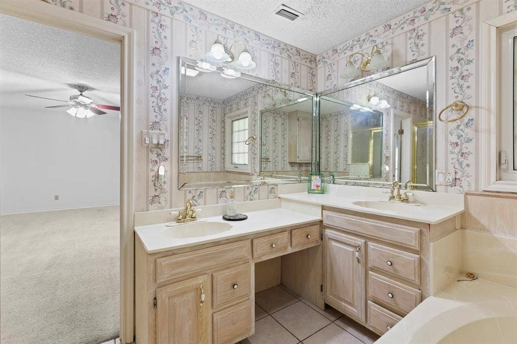 1656 Pineview Lane, Hideaway, TX 75771 Dual vanity with integrated sinks and ample countertop space, complemented by a built-in makeup vanity