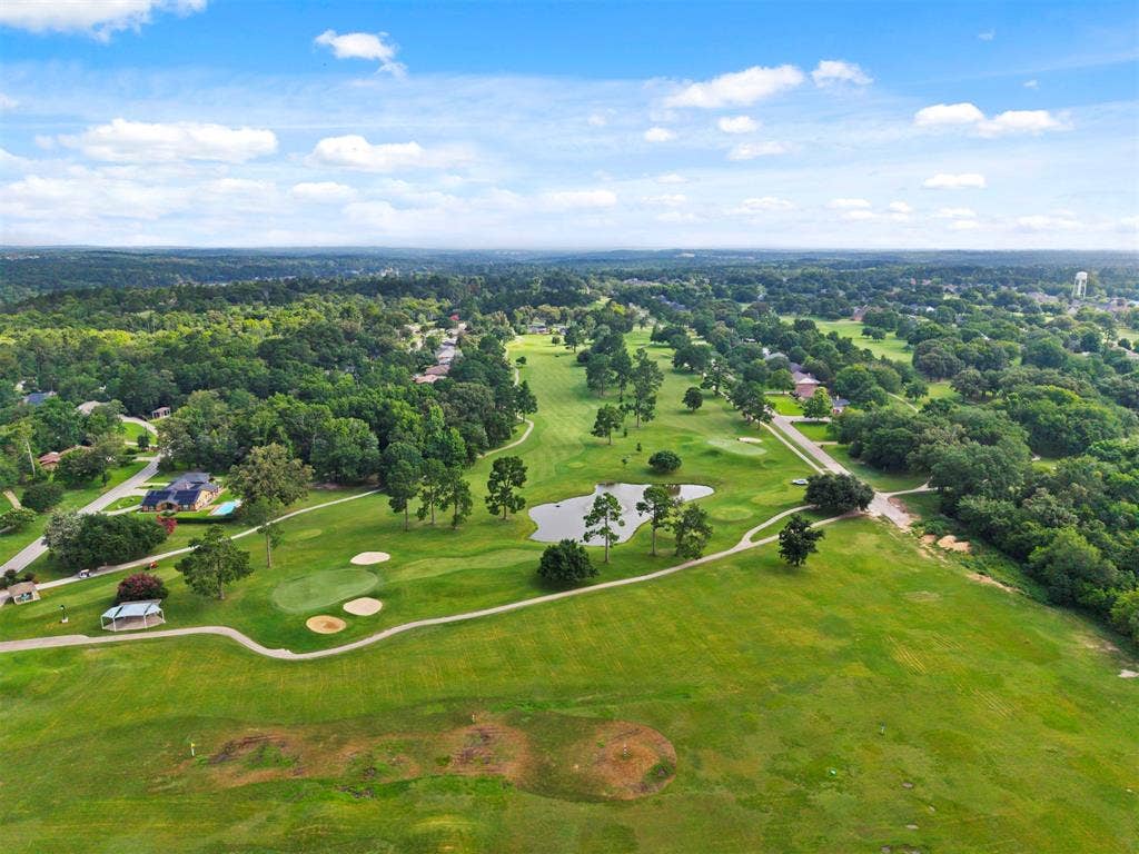 1656 Pineview Lane, Hideaway, TX 75771 Expansive green spaces with a golf course, mature trees, and a tranquil pond