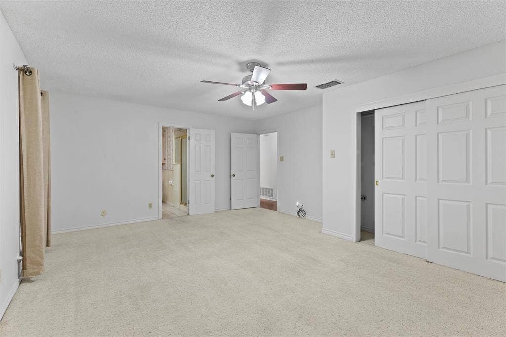 1656 Pineview Lane, Hideaway, TX 75771 Carpeted flooring, ceiling fan, and sliding panel closet doors