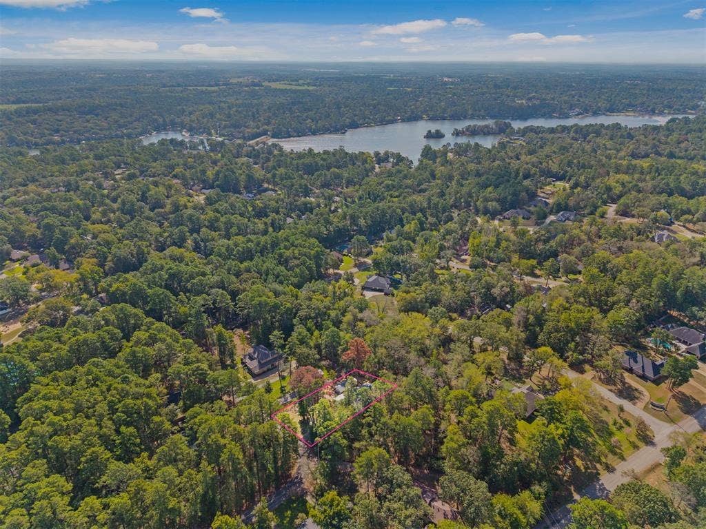1656 Pineview Lane, Hideaway, TX 75771 Expansive wooded property with a substantial body of water in the background
