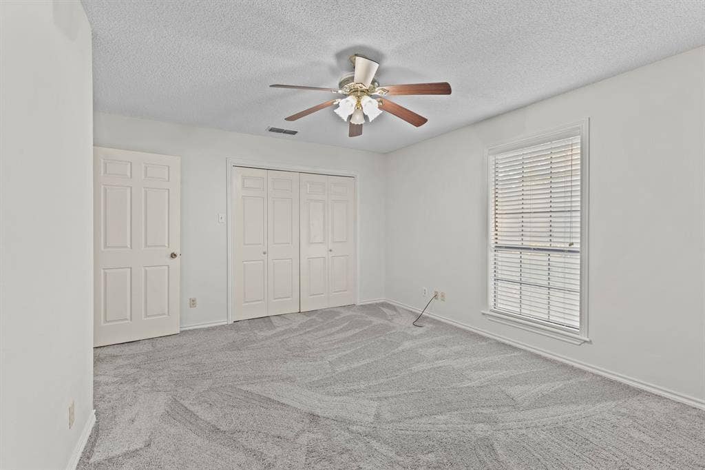 1656 Pineview Lane, Hideaway, TX 75771 Neutral-toned walls complement the textured gray carpeting