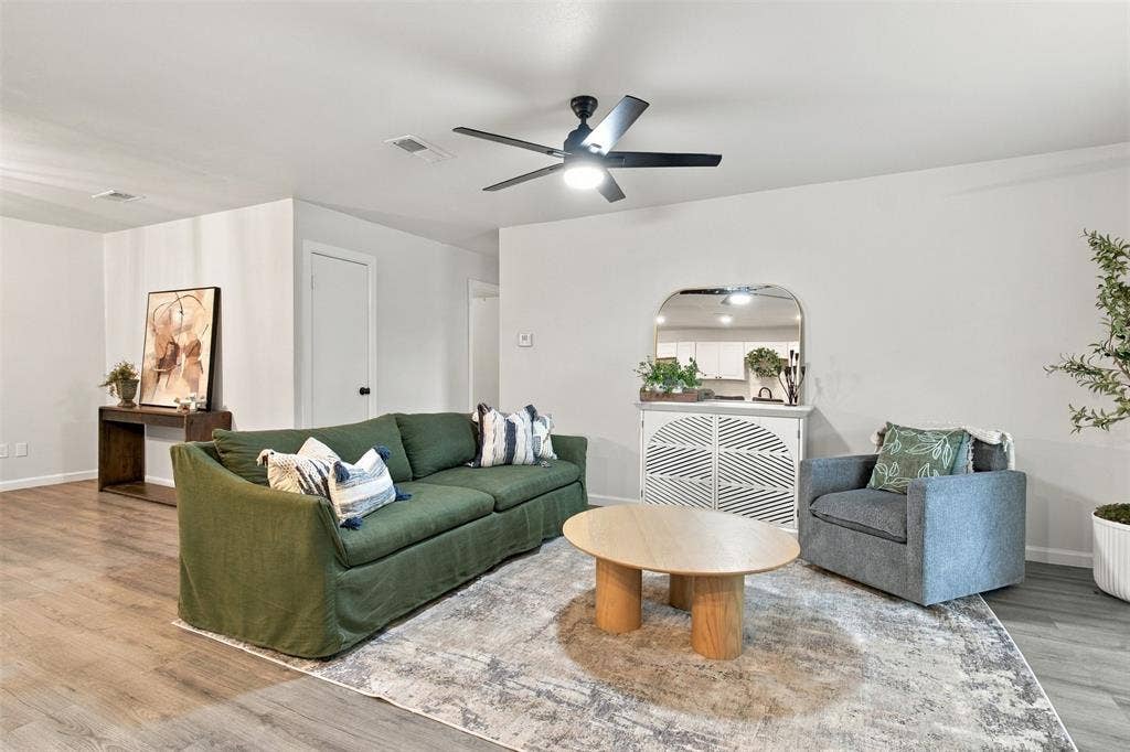 Recessed lighting, wood-finish flooring, and a ceiling fan with integrated lighting