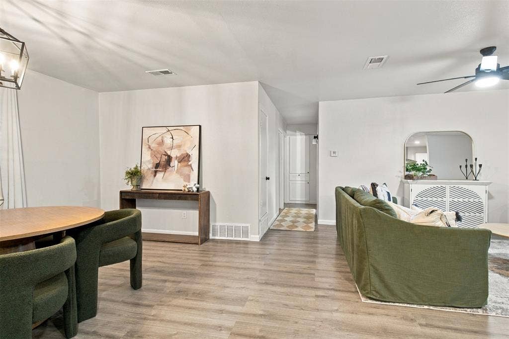 Wood-finish flooring throughout, with recessed lighting and a ceiling fan