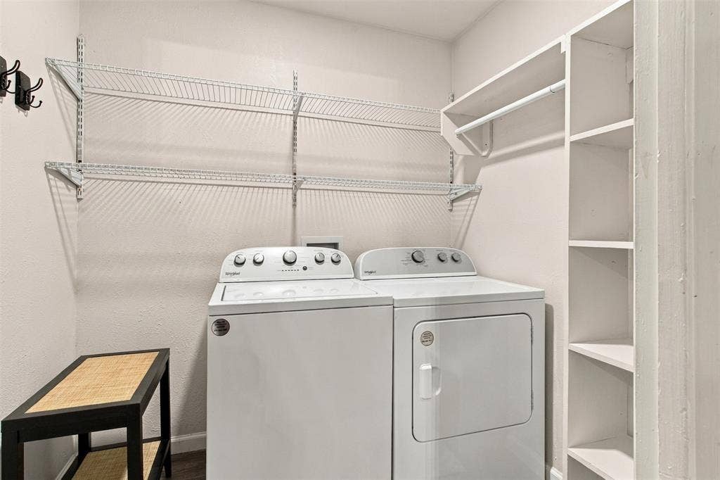 Equipped laundry space featuring a washer and dryer, wire shelving, and built-in shelving with a hanging rod