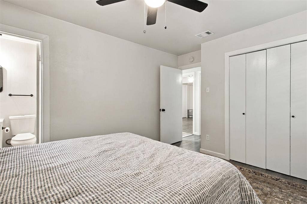 White walls complement the dark wood-finish flooring