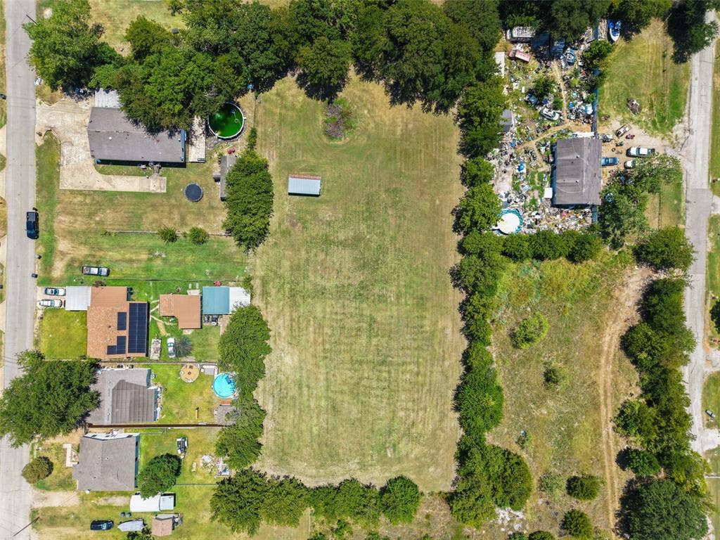 74 Sarah Lane, Dallas, TX 75253 Expansive lot with cleared land, bordered by mature trees and residential properties