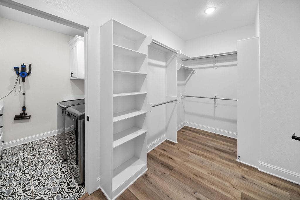 16139 Eagle Lane, Lindale, TX 75771 Walk-in closet with wood-finish flooring, built-in shelving, and metal hanging rods