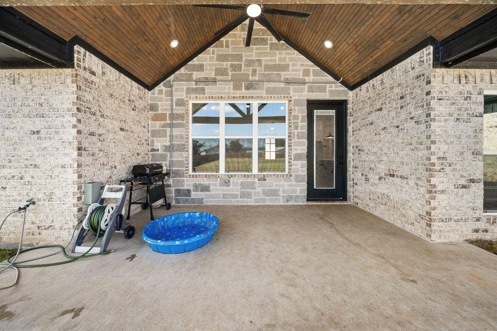 16139 Eagle Lane, Lindale, TX 75771 Expansive covered patio featuring a wood-finish ceiling, exposed beam accents, and integrated ceiling fan