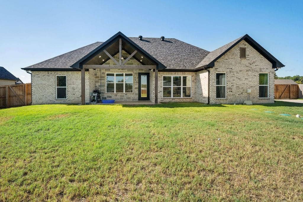 16139 Eagle Lane, Lindale, TX 75771 Light-toned brick exterior with a dark shingle roof and black trim