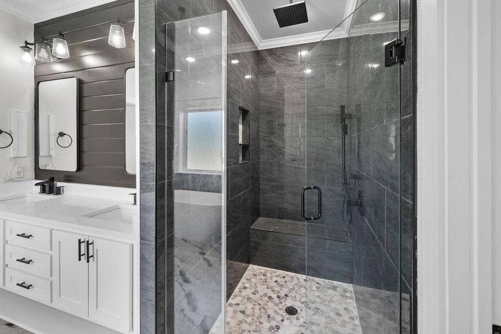 16139 Eagle Lane, Lindale, TX 75771 Glass-enclosed shower with stone tile surround, integrated bench, and rainfall showerhead