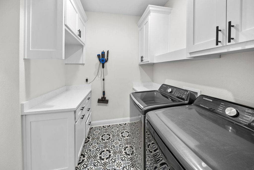 16139 Eagle Lane, Lindale, TX 75771 White shaker-style cabinetry with black hardware, white countertops, and patterned tile flooring