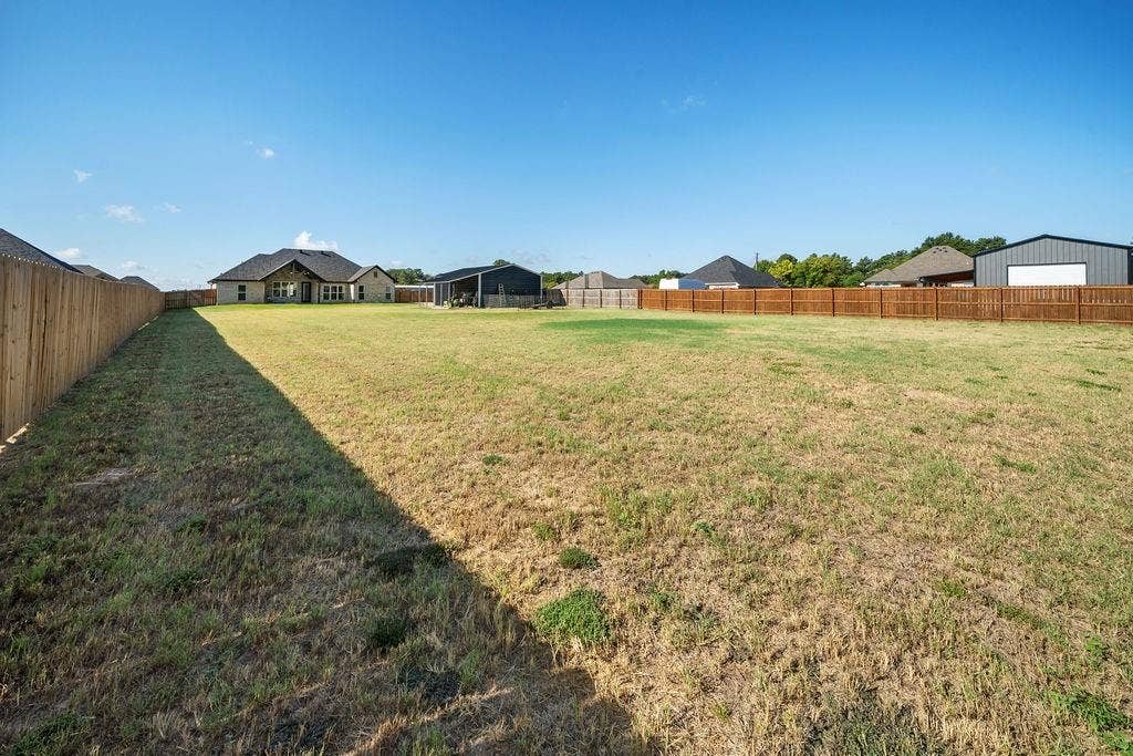 16139 Eagle Lane, Lindale, TX 75771 Spacious yard featuring a full wood fence and ample green space