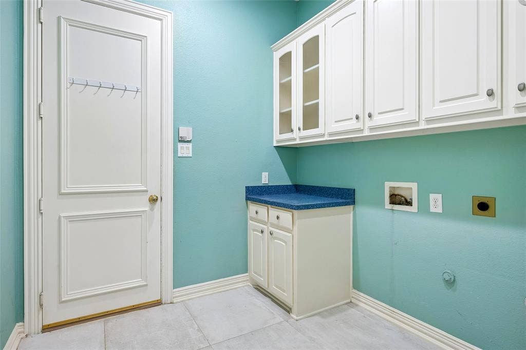 8141 Rosemont Drive, Plano, TX 75025 Large laundry room with an abundance of cupboards.