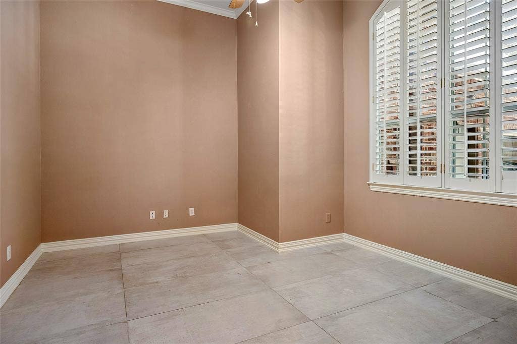 8141 Rosemont Drive, Plano, TX 75025 Secondary bedroom with ceiling fan, custom tile and custom windows with shutters.