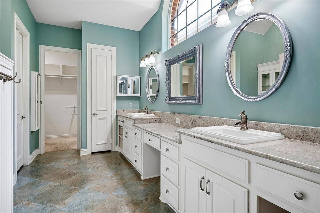 8141 Rosemont Drive, Plano, TX 75025 Updated primary bathroom with custom tile, double sinks, built in vanity, linen closet, walk in closet.
