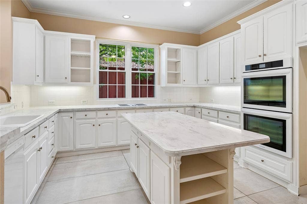 8141 Rosemont Drive, Plano, TX 75025 Beautiful all white kitchen with large double ovens, island.
