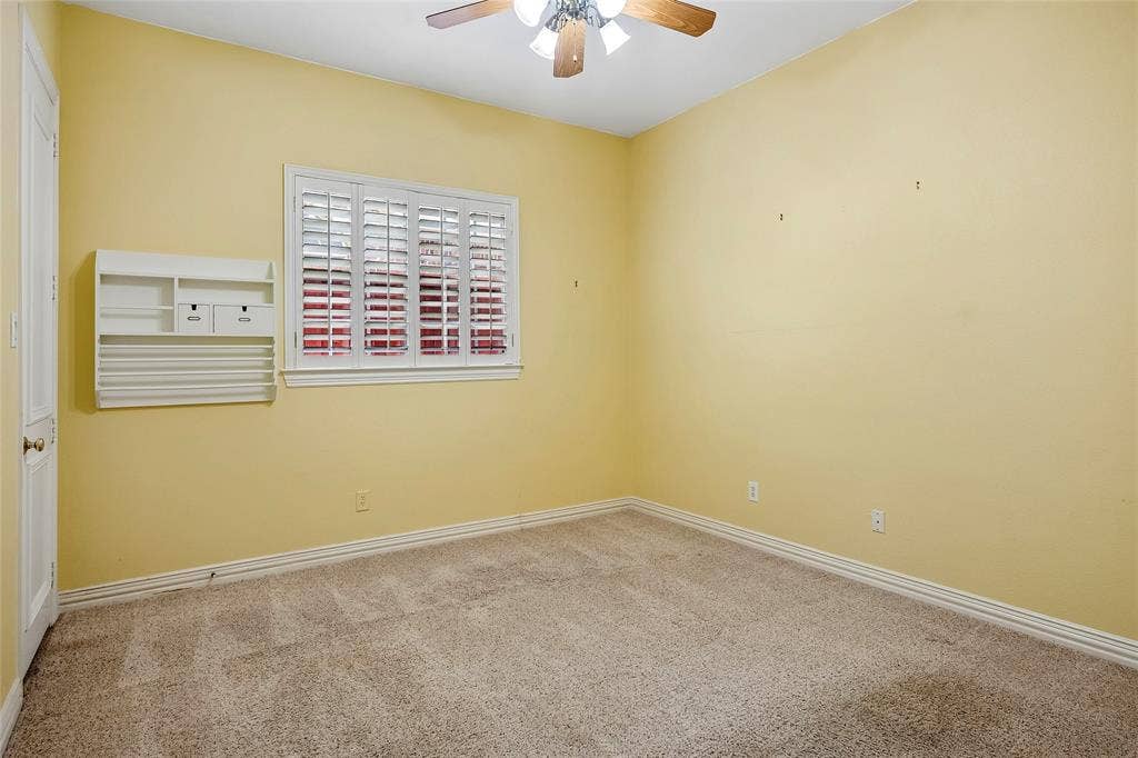 8141 Rosemont Drive, Plano, TX 75025 Window with shutters, ceiling fan, wall built-in.